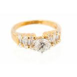 A diamond solitaire 18ct yellow gold ring, diamond set three row shoulders,