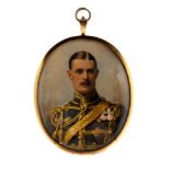 An Edwardian oval portrait miniature of a moustached gentleman in military unifrom wearing medals,