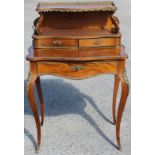 A 19th Century Louis XVI style French bonheur-du-jour, the upper section with a brass gallery edge,