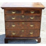 An early 18th Century laburnum and walnut veneered chest of drawers,