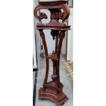 An Empire style mahogany carved torchere,