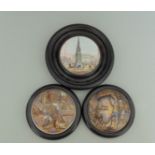 Three Staffordshire Prattware polychrome pot lids, mounted in black wooden frames,