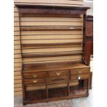 A George II oak dresser and rack, the rack with three plate shelves, the base having five drawers,