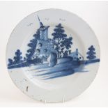 A large tin glaze charger with hand painted design, depicting buildings,