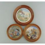 Three Staffordshire Prattware polychrome pot lids, mounted in light wooden frames,