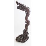 A Chinese carved wooden stand, 20th Century, in the form a dragon, possibly for a dinner gong,