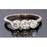 A diamond three-stone 18ct white gold ring,