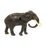 A Japanese bronze study of a strolling elephant, Meiji period, 1868-1912, with ivory tusks,