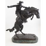 After Frederick Remington (American, 1861-1909), 'Bronco Buster', bronze, signed,
