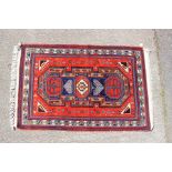 A Persian rug, red ground,