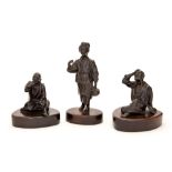 A series of three Japanese bronze studies, Meiji period, 1868-1912, modelled as two men,