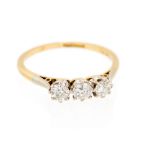 A gold and diamond three-stone ring, set with three round cut diamond total weight approx 0.