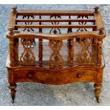 A mid Victorian walnut three tier Canterbury, serpentine fronted,