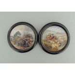 Two Staffordshire Prattware polychrome pot lids, mounted in black wooden frames,