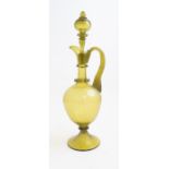 A late 19th Century Venetian Revival olive green glass claret jug and stopper, circa 1880 (s.