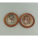 Two Staffordshire Prattware polychrome pot lids, mounted in light wooden frames.
