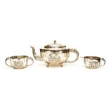 An Indian silver part tea service: Elephant handles, embossed decoration, teapot,
