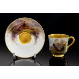 A Royal Worcester cabinet cup and saucer, painted by James Stinton with pheasants in thicket,