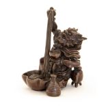 A Japanese bronze study of a demon seated feasting on noodles, Meiji period, 1868-1912,