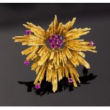 An 18ct yellow gold stylised star burst ruby set brooch,