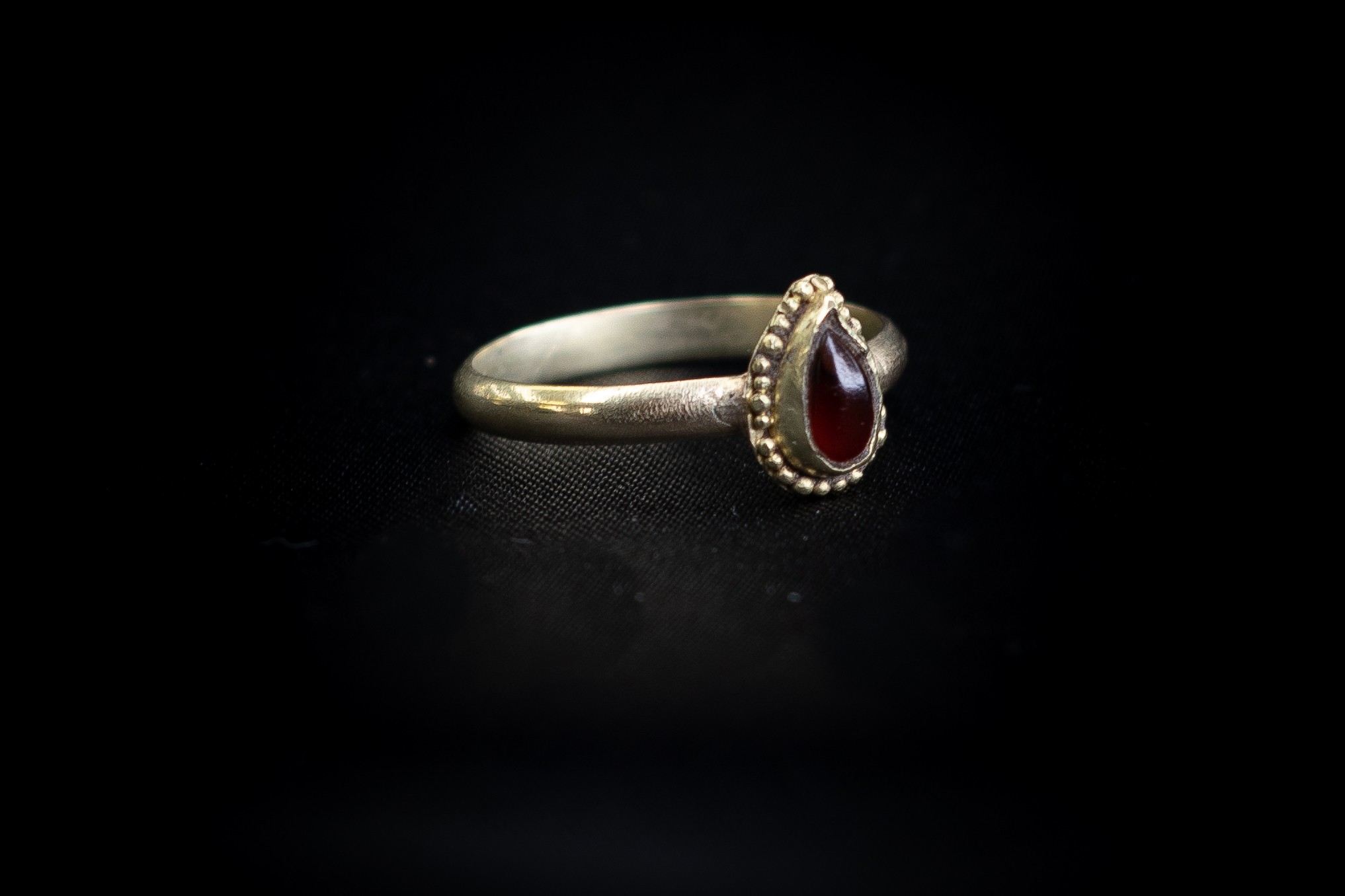 Medieval Gold ring set with Teardrop shaped red stone. Ring size V and a half. Total weight 3.