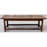 An 18th Century joined elm long table, the plank top with cleated ends,