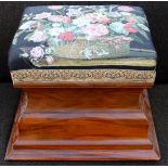 An early 20th Century walnut framed box stool, the seat upholstered floral patterned woolwork,