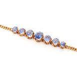 A graduated sapphire and rose gold bracelet, set with seven oval Ceylon sapphires,