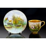 A Royal Worcester cabinet cup and saucer, painted by W H Austin with waterlily,