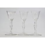 A set of three George III style wine glasses, rounded bowls with star and lens border,