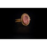 Roman (2nd century AD) A gold ring with band formed of plaited wires framing a plain centre;