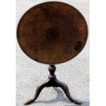 A George II mahogany tilt-top tripod table, the single plank top with a dished edge,