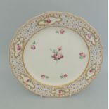 A Derby dessert plate, deep border with six gilded panels hand painted with pink roses,