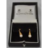 A pair of 9ct. gold and pearl set drop earrings, each having pierced conical gold mount set single