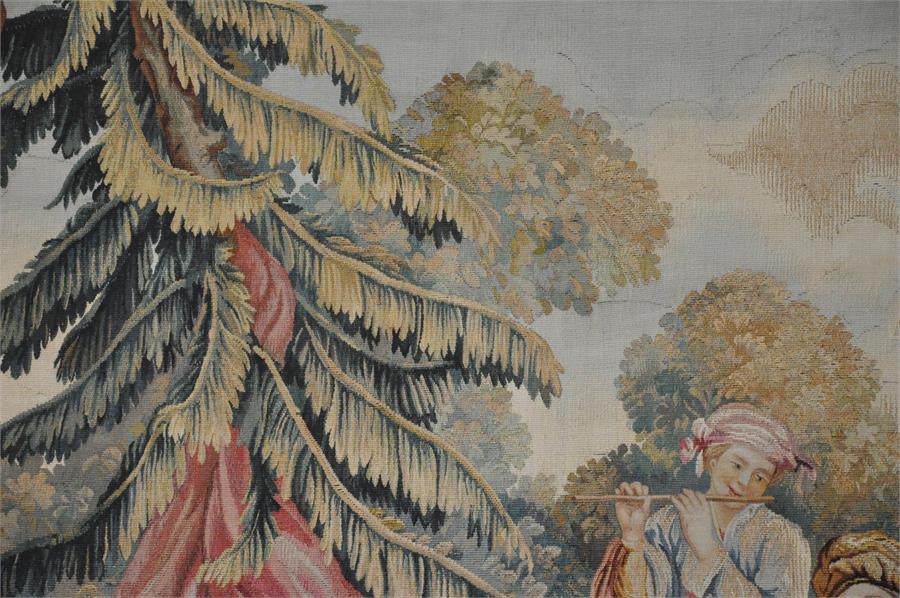 A large Aubusson tapestry, French 20th century, depicting a couple and musician within a forested - Image 2 of 5