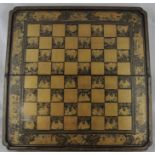 A Chinese export lacquer games box, circa 1850, externally gilded with draughts board within