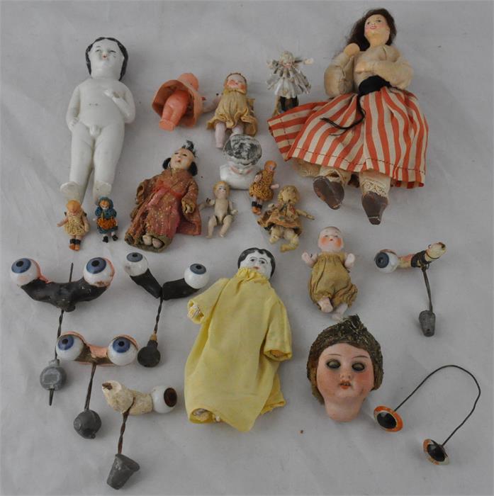 A signed dolls head, together with a collection of miniature dolls and doll's glass eyes. (qty)