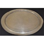 Liberty and Co, a Tudric pewter tray, planished oval form, with concave rim. English Pewter,