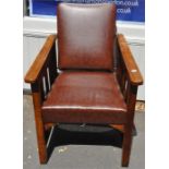 An Arts and Crafts oak reclining chair, having brass mounted four slot ladder for reclining back,