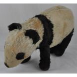 A well loved Merrythought Panda, standing on all fours, approx. 45cm long x 25cm high.