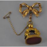 A Victorian gilt metal fob, of rectangular form, with openwork scroll mount, set carnelian and