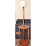 An Art Deco lamp stand with glass globe, the central support to three circular undertiers, 182cm