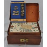 A Chinese bone and bamboo Mahjong set in hide case, 148 blocks, each block decorated in colours with