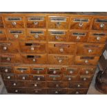 A pair of walnut apothecary cabinets, early 20th century, each fitted with twenty drawers, thirty