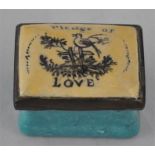 An 18th century Bilston enamel patch box with original mirror the top inscribed' Pledge of Love',