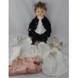 A Horsman 1920's doll, with original clothes together with a quantity of dolls clothes. (qty)