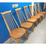 A set of modern design Ercol blonde Elm spindle back chairs.