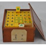 A Mahjong set with ivorine blocks bearing character marks, motifs and conspicuous objects, contained