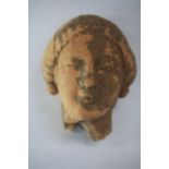 Greek Head of a Kore, 5th century BC. A terracotta head of a Kore maiden (possibly the goddess