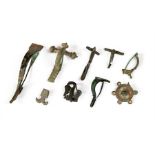 A group of bronze fibulae and brooches including a superb enamelled shield brooch and a bird brooch.